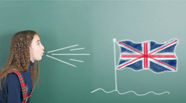 istock Pre-adolescent girl blowing on Great Britain flag 1283352954