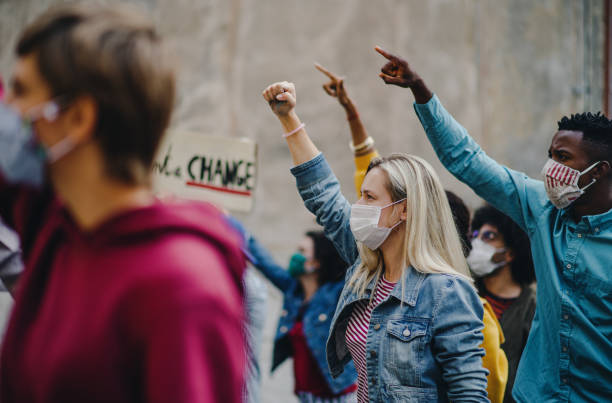 istock Group of people activists protesting on streets, strike and demonstration concept. 1283353686