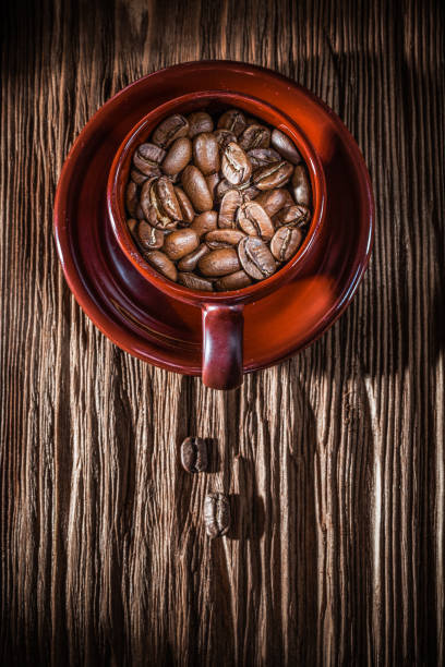istock Coffee beans cup saucer on vintage wooden board 1283353704