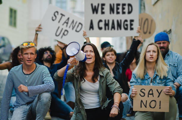 istock Group of people activists protesting on streets, strike, demonstration and coronavirus concept. 1283354247