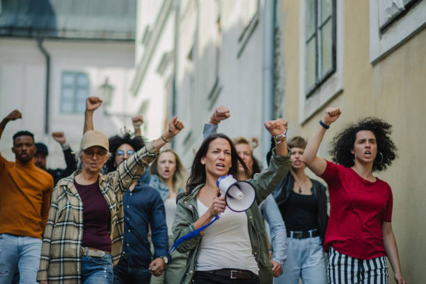 istock Group of people activists protesting on streets, strike, demonstration and coronavirus concept. 1283354265