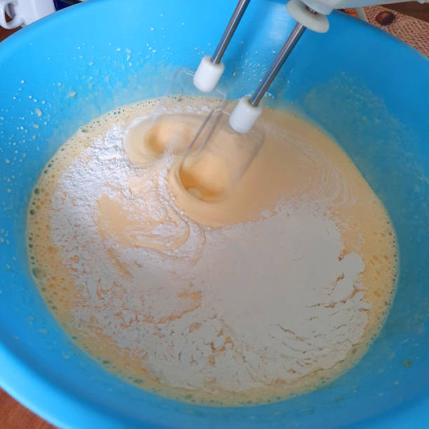 istock Preparing the cake. Mixing flour with dough with a mixer. 1283354489