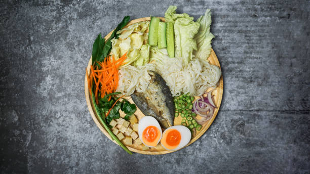 istock Spicy rice noodle salad with herb on cement table. 1283354941