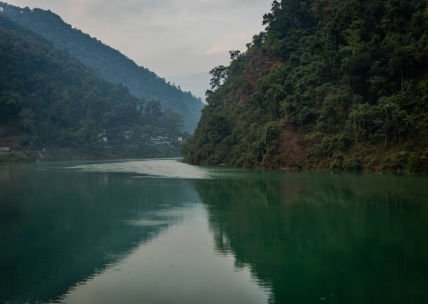 istock river flowing calm in blue color with mountain reflection 1283356062