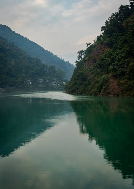 istock river flowing calm in blue color with mountain reflection 1283356068