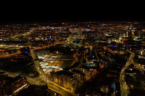 Night time aerial photo of the the town centre of Leeds in the UK, showing the West Yorkshire British city from above in the evening time