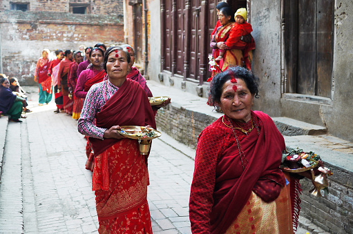 2010 January 30: unidentified nepalese woman are queueing in the wedding in kathamandu, bhaktapur durbar square.red color will be used in traditional nepalese wedding