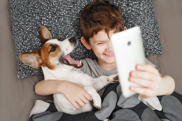 istock Little boy takes a selfie with a dog. 1283360568