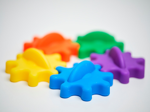 Colorful cogs representing a teamwork metaphor.