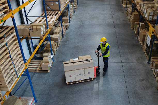 istock High-angle view of man worker working indoors in warehouse, coronavirus concept. 1283362069