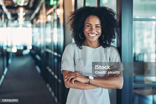 Young Businesswoman Standing In The Corridor Stock Photo - Download Image Now - Women, Expertise, Business