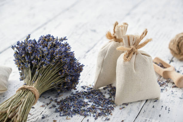 istock Dry lavender flower bouquets and aromatic sachets on white wooden table. 1283364842