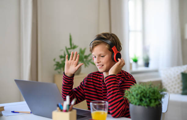 istock Schoolboy having online lesoon indoors at home, coronavirus concept. 1283365572