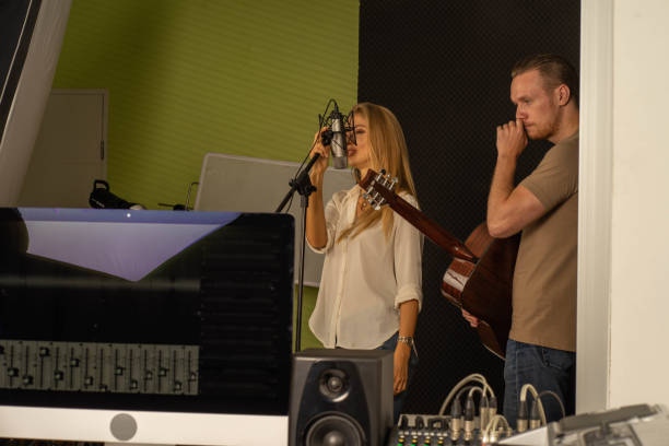 istock young attractive Caucasian woman musician singer in recoding studio with microphone. Performance arts concept. 1283365634