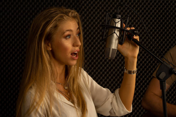 istock young attractive Caucasian woman musician singer in recoding studio with microphone. Performance arts concept. 1283365642