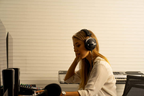 istock young attractive Caucasian woman musical sound composer producer in recoding studio with headphone. Performance arts concept. 1283365669