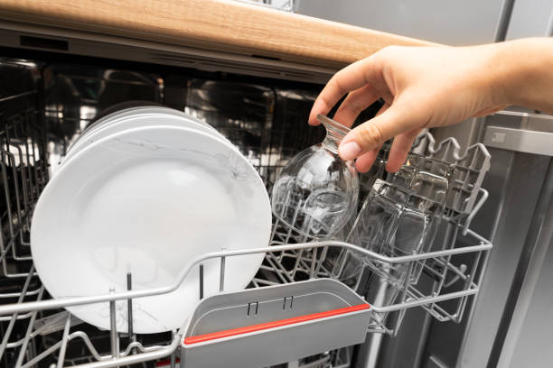 istock Hand takes a clean glass from the dishwasher 1283365770