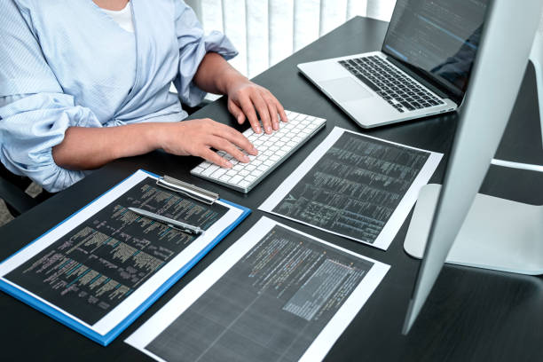 Female Developer programmer working on coding program software computer, Writing website and development database technology in office stock photo