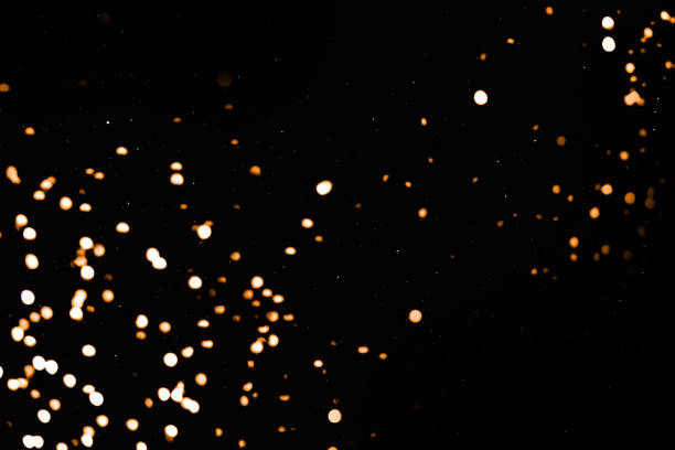 istock Splash of golden sparkles on black background. Bokeh lights. Sparkling texture 1283368174
