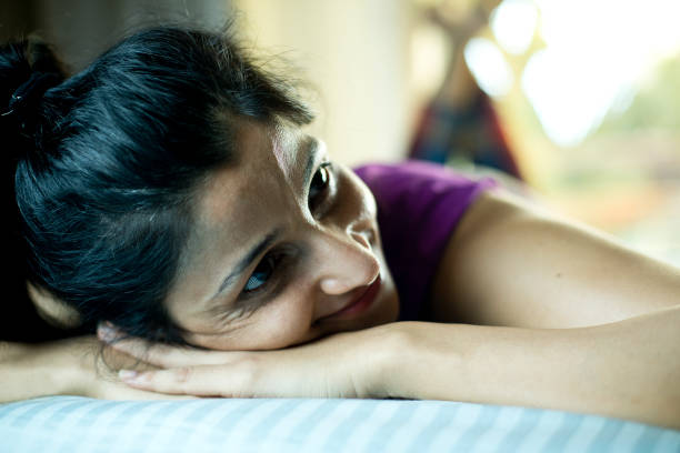 istock Woman relaxing on bed at home 1283368436