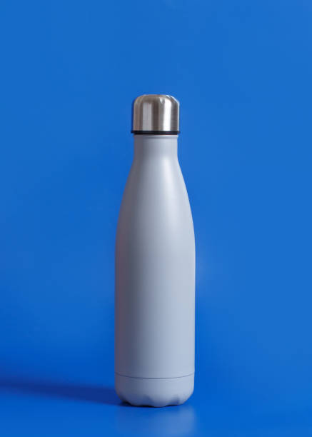 istock Close-up of grey reusable steel bottle on blue background 1283369165