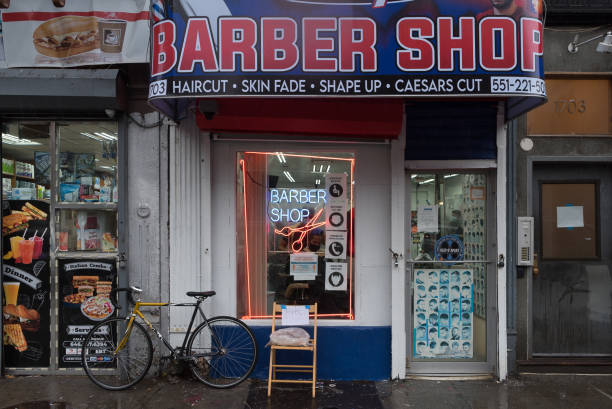 Manhattan, New York. October 29, 2020. A man wearing a mask gets an haircut at a barber in east Harlem.