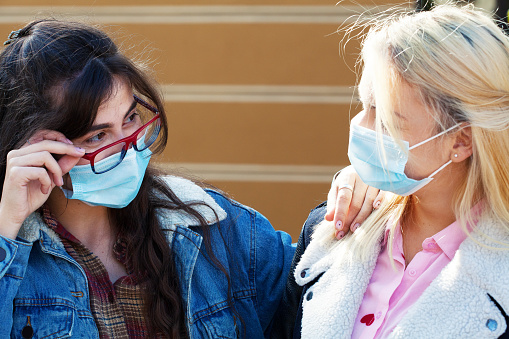 Young women wearing protective face masks