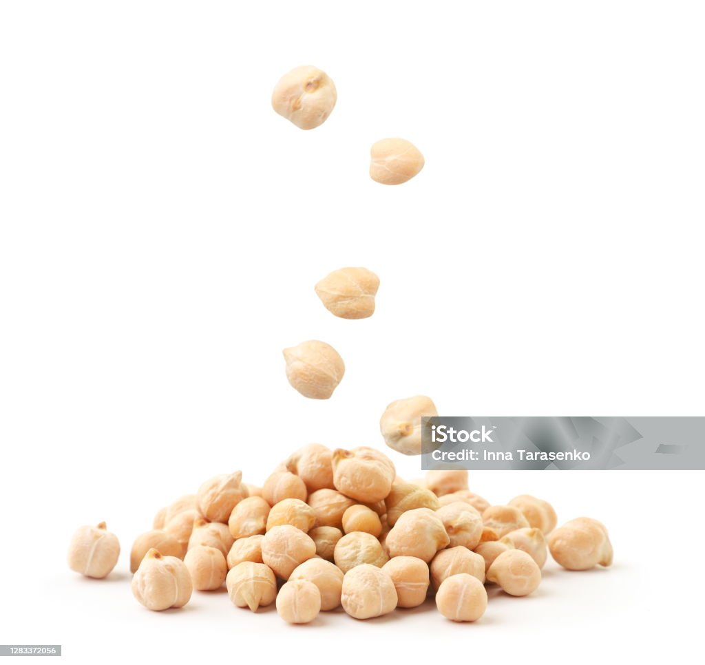 Chickpeas flies and falls on a bunch on a white background. Isolated Chickpeas flies and falls on a bunch close-up on a white background. Isolated Chick-Pea Stock Photo