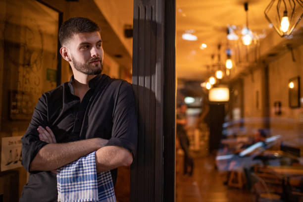 istock Beautiful young hard working man standing in front of cafeteria 1283372255