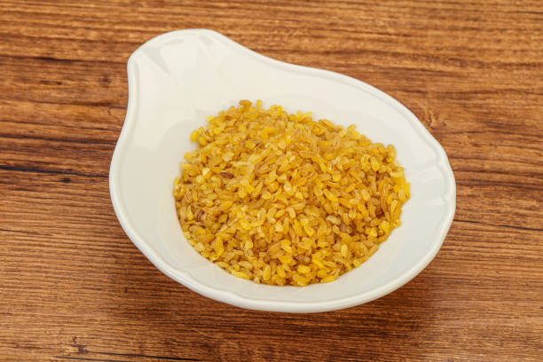 istock Vegetarian cuisine - dry bulgur for cooking 1283372577