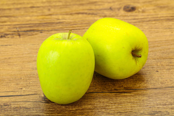 istock Two ripe green sweet apples 1283373063