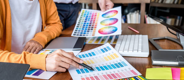 istock Two colleagues creative graphic designer working on color selection and drawing on graphics tablet at workplace 1283374024