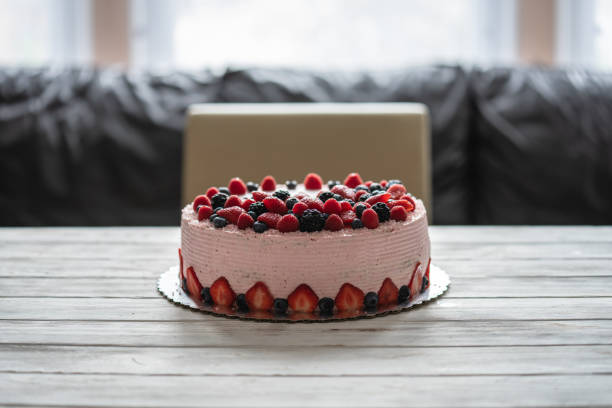 Home made cake with berries. Cake with Strawberry, blackberry, blueberry, and raspberry on a table.