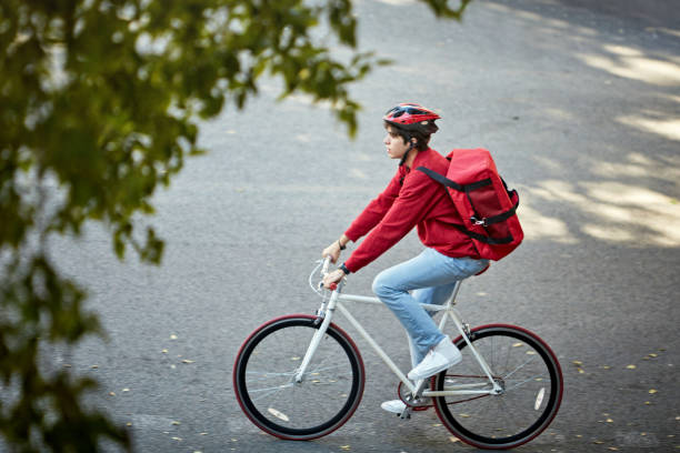 istock Pizza Delivery Person Cycling to Next Delivery 1283374587