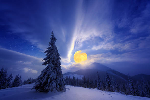 istock Night winter landscape with full moon in the mountains 1283379771