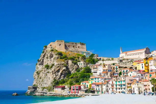 Photo of Watercolor drawing of seaside town village Scilla with old medieval castle on rock Castello Ruffo, colorful traditional typical italian houses on Mediterranean Tyrrhenian sea coast, Calabria, Italy