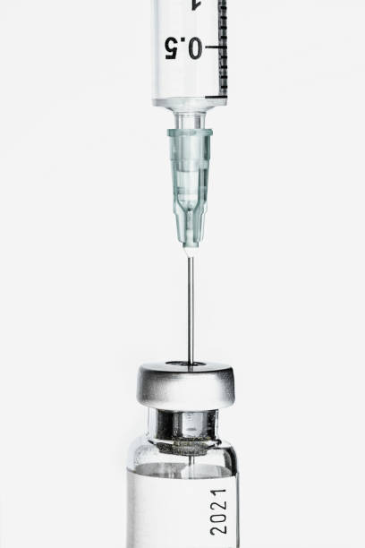 close-up de seringa e soro/vacina covid-19 com números do ano de 2021 - injeção insulina luva - fotografias e filmes do acervo
