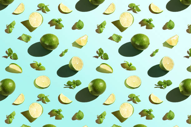 istock Seamless texture of lime with mint on a blue background. Top view. 1283382427