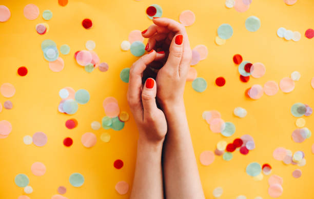 istock Crop woman with red nails on yellow background 1283382675