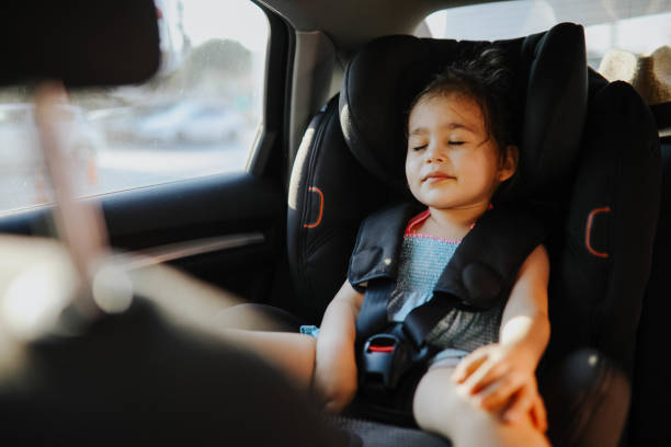 little cute girl sleeping on car seat in car - car baby baby car seat child imagens e fotografias de stock