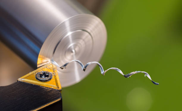 Beautiful spiral metal swarf. Close-up of turning on green background stock photo