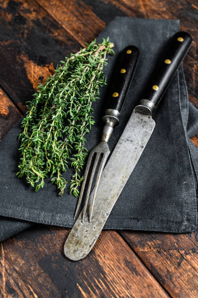 istock Old cutlery knife and fork. Dark Wooden background. Top view 1283384967