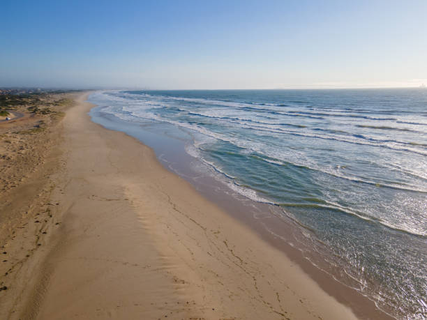 istock Aerial view of waves breaking into coastline 1283387186