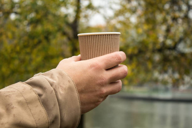 istock a cup of cofee in a male hand 1283387216
