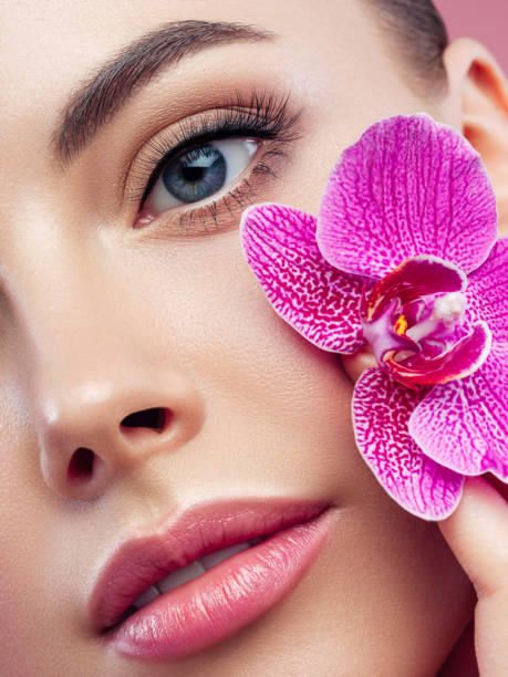 istock Beautiful young woman with flower 1283387523