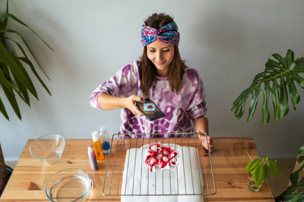 Young woman making tie dye at living room
