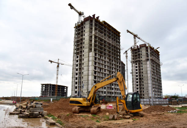 istock Excavator and mini excavator during excavation and road construction works at construction site 1283388775