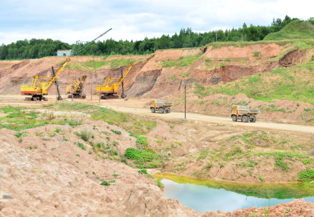 istock Excavators, mining trucks, wheel loader and bulldozer work in dolomite quarry 1283389973