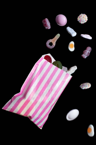 Bag of pick and mix falling Spilt and falling bag of various candy pick and mix stock pictures, royalty-free photos & images