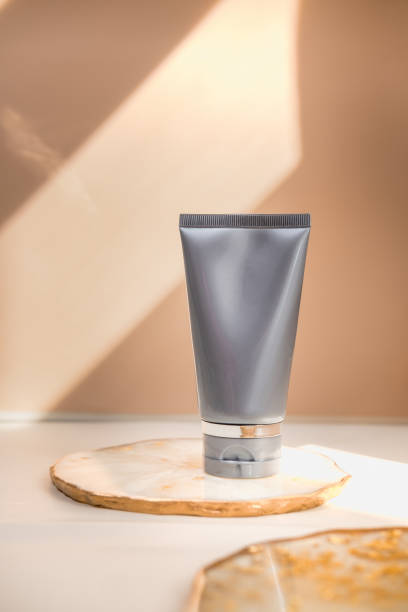 istock Grey cosmetic tube on neutral pastel nude background 1283390156